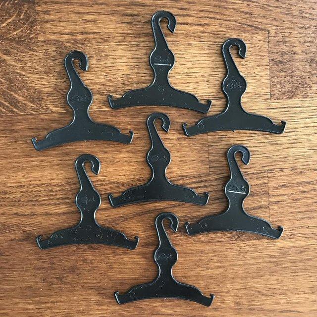 Preview of the first image of 7 vintage 1960's Sindy doll black plastic hangers..
