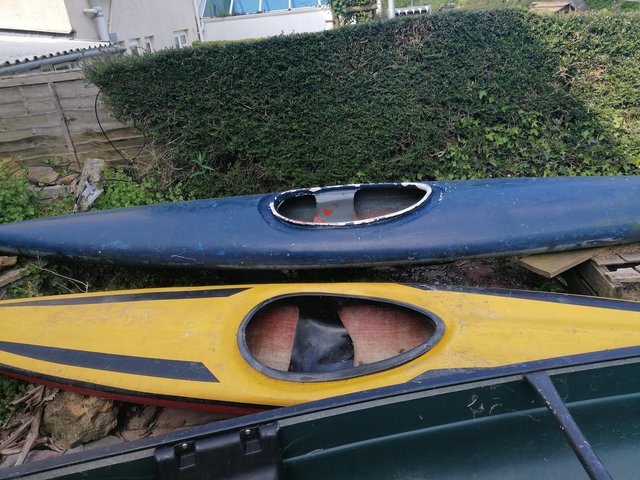 Preview of the first image of Yellow Perception kayak plus unknown blue kayak.
