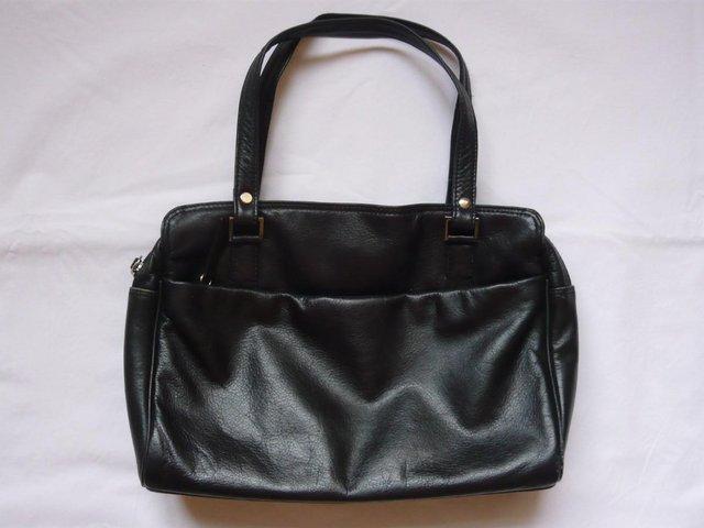 Preview of the first image of Handbag - black leather with fabric lining.