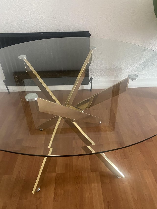 Stylish round glass dining table with four black suede chair — photo 2 of 4