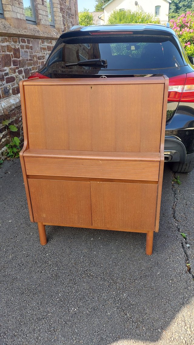 Preview of the first image of Retro teak bureau with cupboard, drawer and drop leaf door..