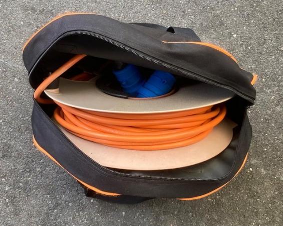 Image 1 of Caravan power cable on storage reel, in zipped storage bag