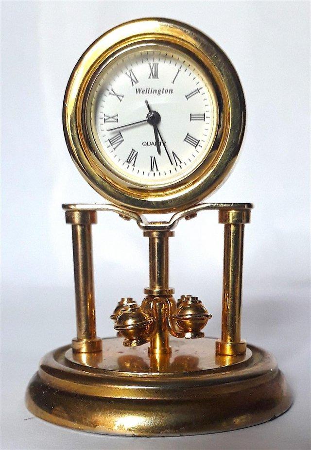 Preview of the first image of MINIATURE NOVELTY CLOCK - A TURNING MANTLE.