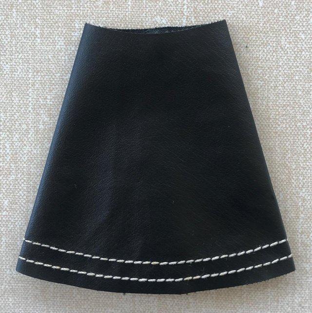 Preview of the first image of Vintage 1967 Sindy Leather Looker black faux leather skirt..