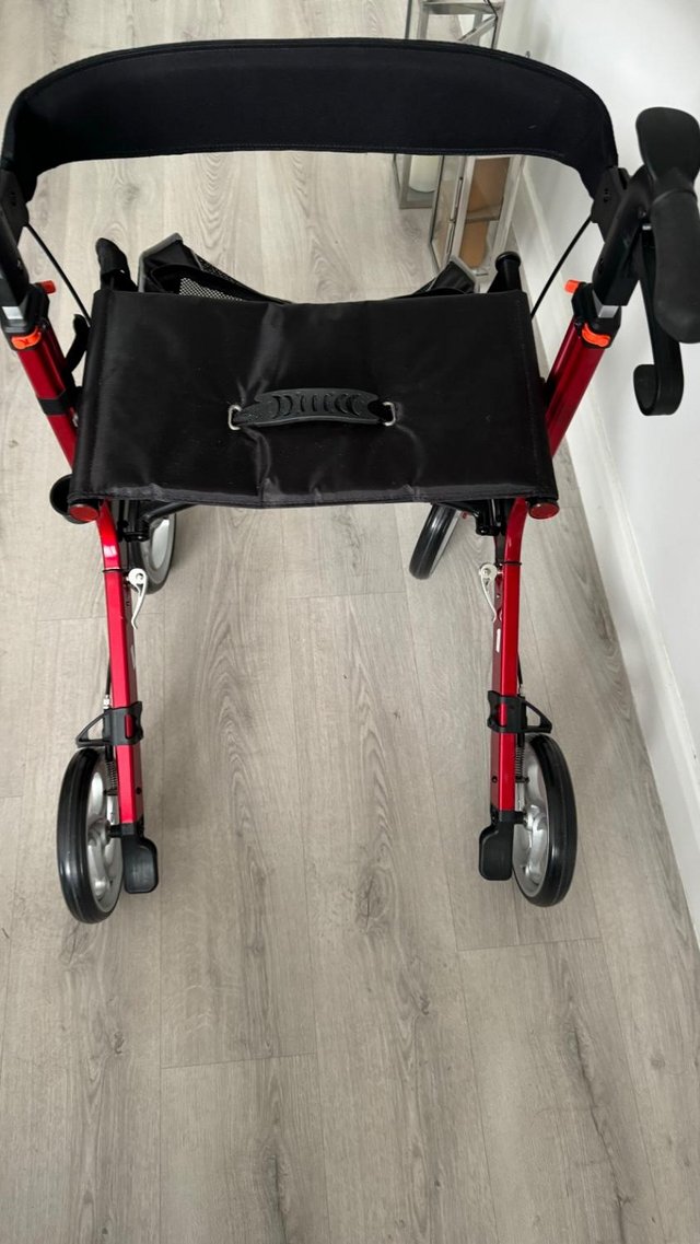 Preview of the first image of Red walker with seat and bag 2 months old.