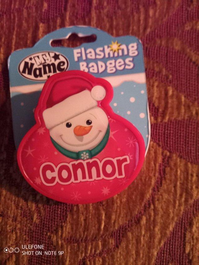 Preview of the first image of Personalised Christmas Badge Connor with flashing red lights.
