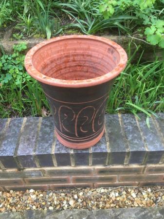 Image 3 of A tall and attractively shaped terracotta plant pot.