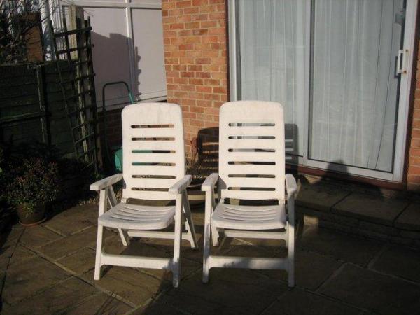 Image 2 of reclining garden chairs, quite large and white coloured.