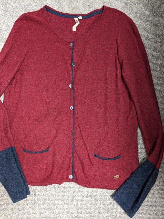 Preview of the first image of White Stuff Ladies Red & Ink Blue round necked cardigan.
