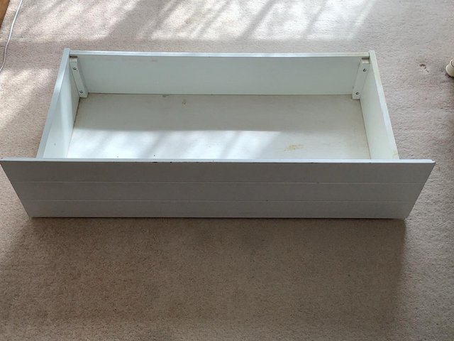 Preview of the first image of Two white under bed drawers on castors.