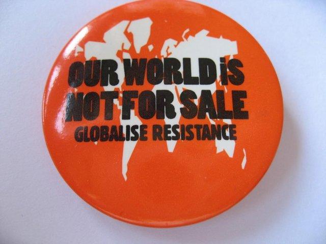 Preview of the first image of Globalise Resistance Our World Is Not For Sale Badge Pin.