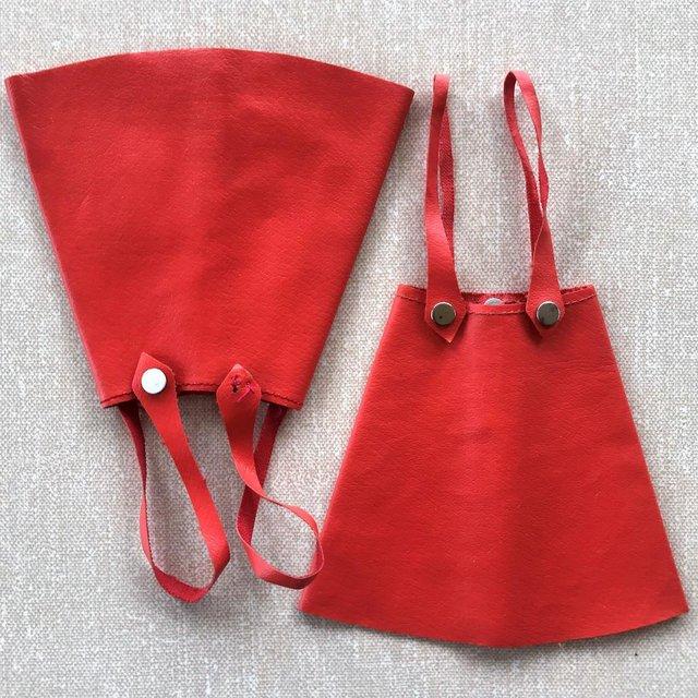 Preview of the first image of 2 vintage 1960s Sindy Leather Looker red faux leather skirts.