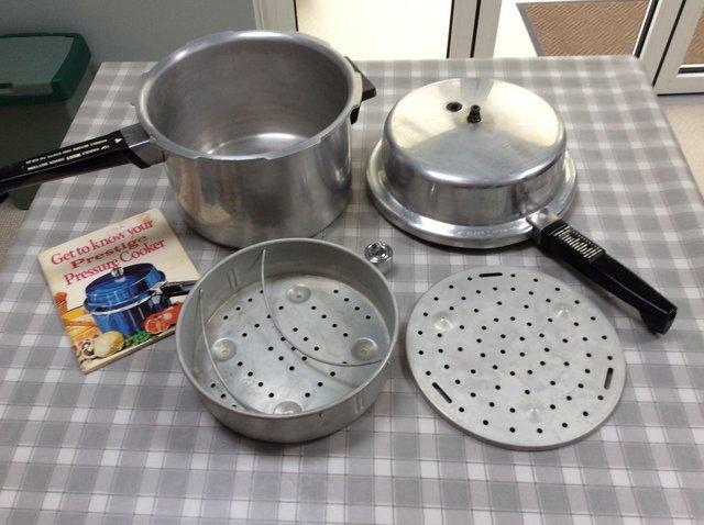 Preview of the first image of Prestige Pressure Cooker with accessories.