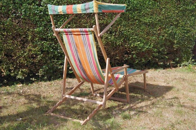 Preview of the first image of Vintage wooden deck chair with leg rest and canopy.