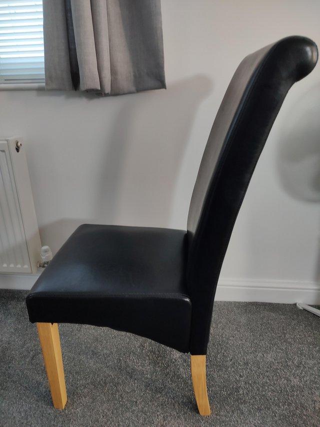 Preview of the first image of 2 BLACK HIGH BACK SKIRTED DINNING CHAIRS WITH OAK LEGS  £70.
