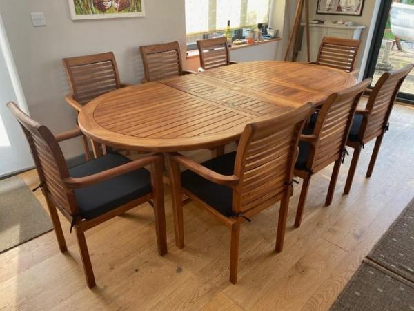Image 1 of Teak extendable patio table, 8 chairs and parasol