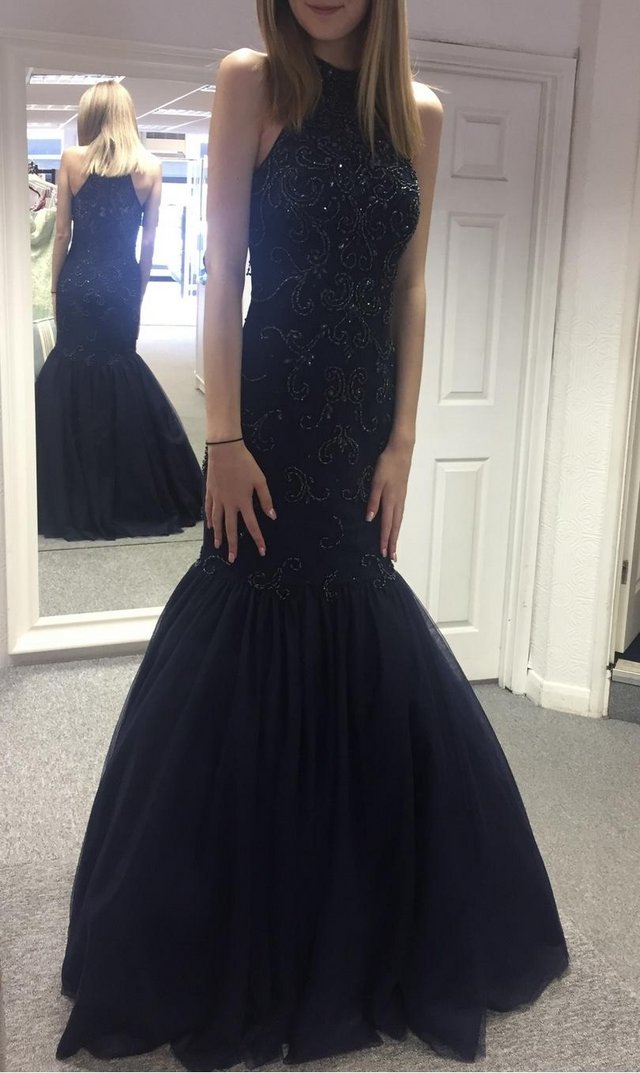 Preview of the first image of Navy prom dress size 4 with fish tail.