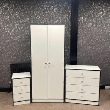 Preview of the first image of NOVA WHITE SET WITH BLACK TRIM WARDROBE CHEST AND BEDSIDE.