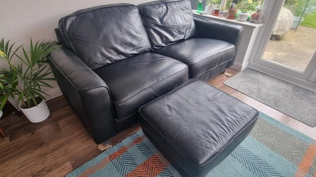 Preview of the first image of FREE Black leather sofa & foot stool..