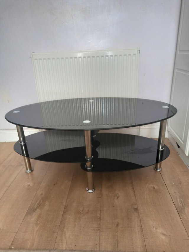 Preview of the first image of 2 tier black glass and chrome coffee table.