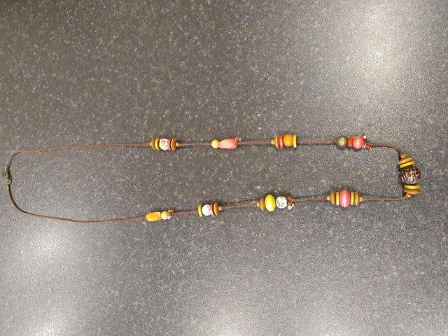 Preview of the first image of Multicoloured boho bead necklace on brown string.