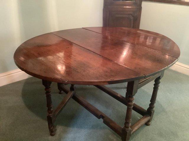 Preview of the first image of Antique oak gate leg drop leaf oval dining table. VGC.
