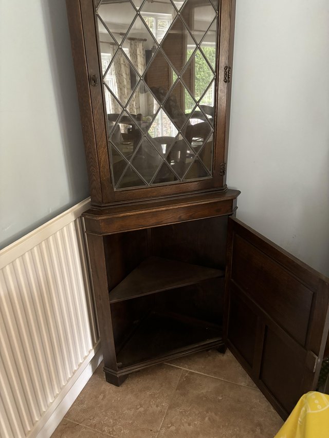 Preview of the first image of Dark wood corner cupboard with half glass door.