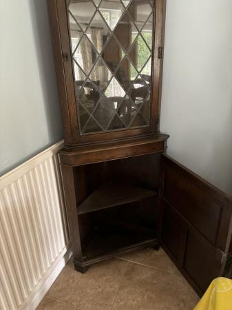 Image 1 of Dark wood corner cupboard with half glass door