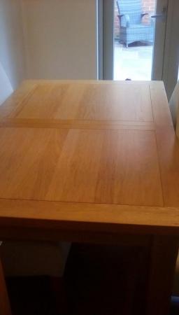 Image 1 of Extendable Oak Dining table and 4 cream leather chairs