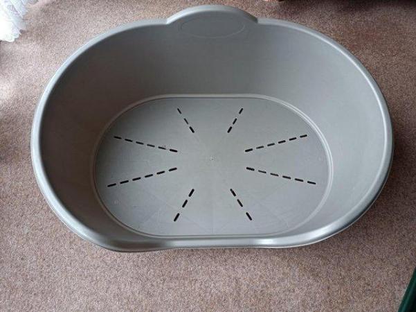Image 1 of Large grey plastic and medium size green dog bed