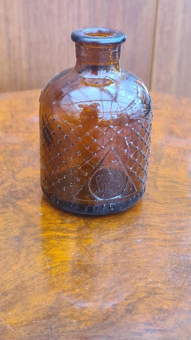 Preview of the first image of Antique 1920s embossed Lysol bottle amber glass.