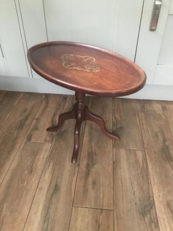 Image 3 of A mahogany oval pedestal table with brass inlay at centre.