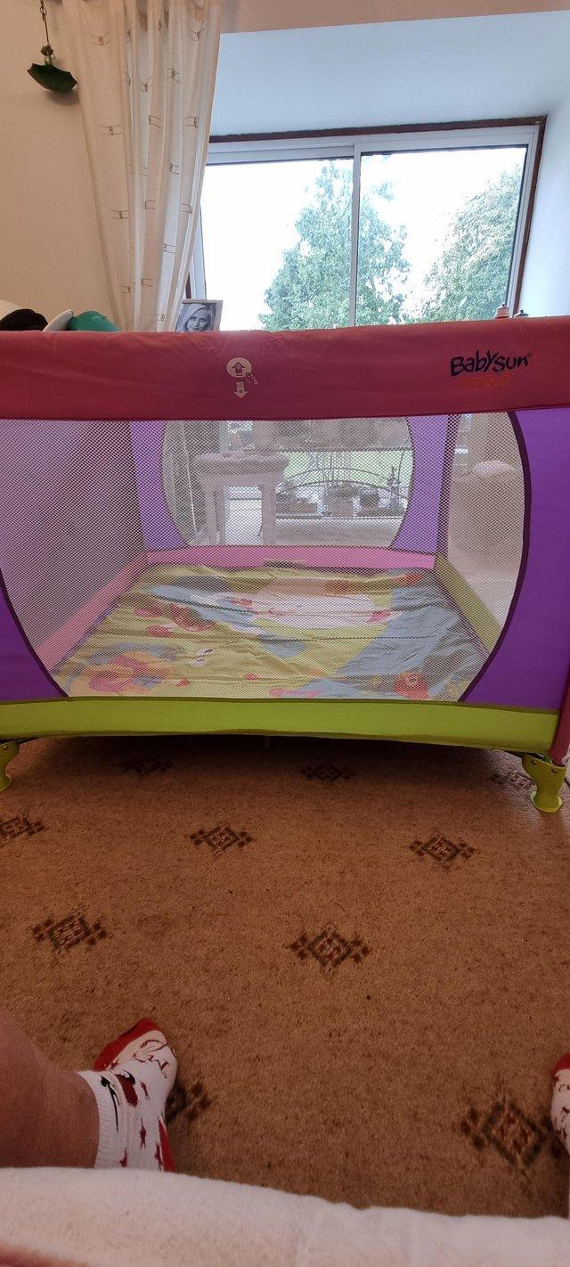 Preview of the first image of Large playpen can ve used as travel cot.