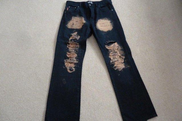 Preview of the first image of Men's Black Ripped Designer Style Jeans.