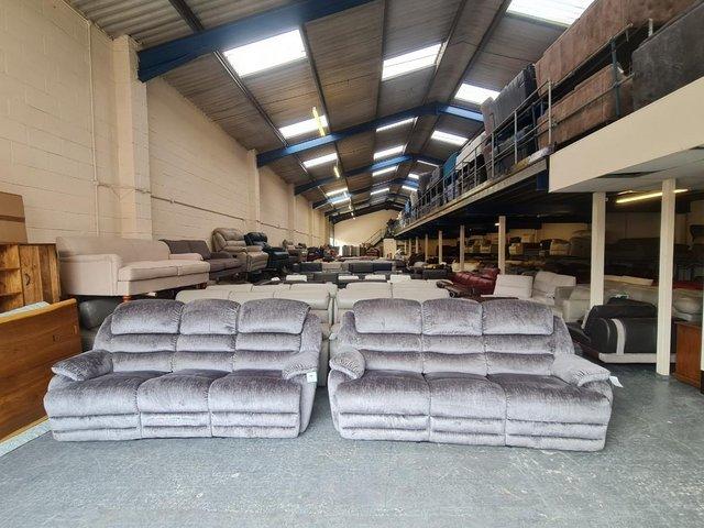Preview of the first image of Farrington grey fabric manual recliner 2 x 3 seater sofas.
