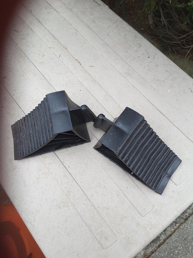 Preview of the first image of Two black plastic caravan wheel chocks.