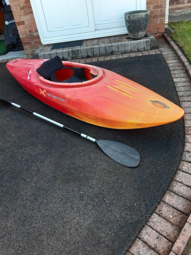 Preview of the first image of Heavy plastic kayak and paddle.