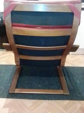Image 4 of a burgundy poang chair and footstool for sale.