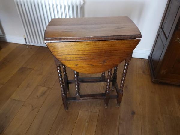 Image 1 of Beautiful solid oak drop leaf table with candle twist legs.
