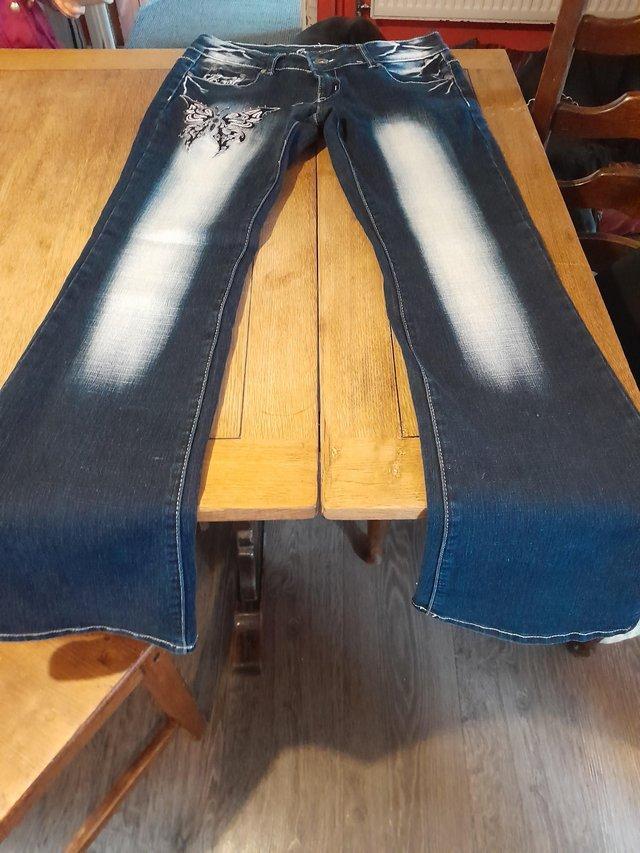 Preview of the first image of Womens jeans with stones on the jeans.