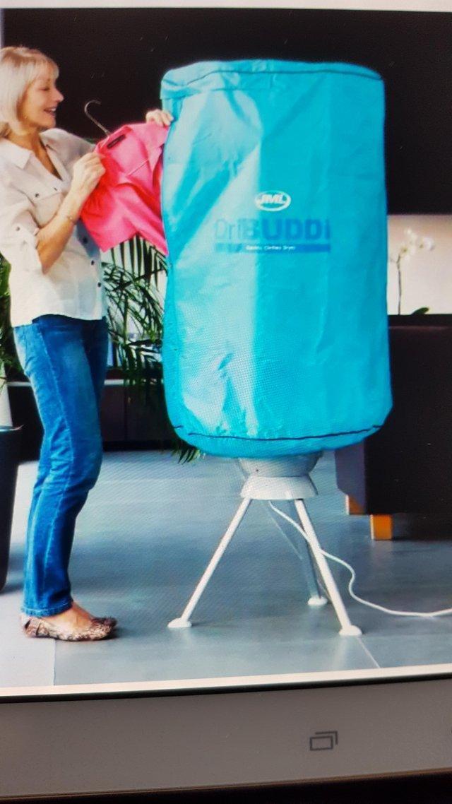 Preview of the first image of J.M.L DriBuddi Covered fan clothes dryer with hangers.