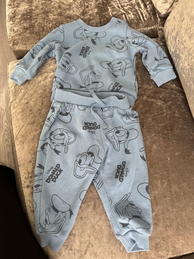 Preview of the first image of 6 - 9 months Donald Duck tracksuit.
