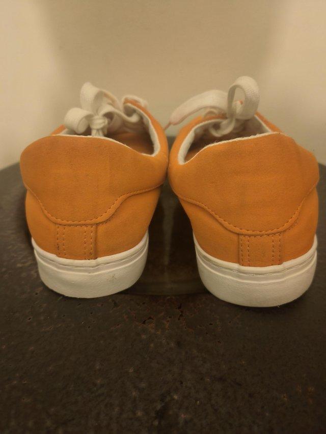 Preview of the first image of New Look orange canvas shoes size 7.