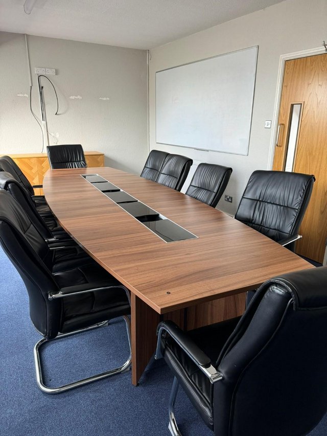Preview of the first image of Wooden office table with 10 chairs.