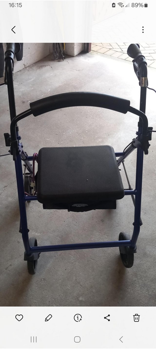 Preview of the first image of Blue four wheel Rollator with seat.