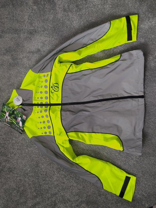 Preview of the first image of Equisafety Charlotte Dujardin yellow reflective jacket mediu.