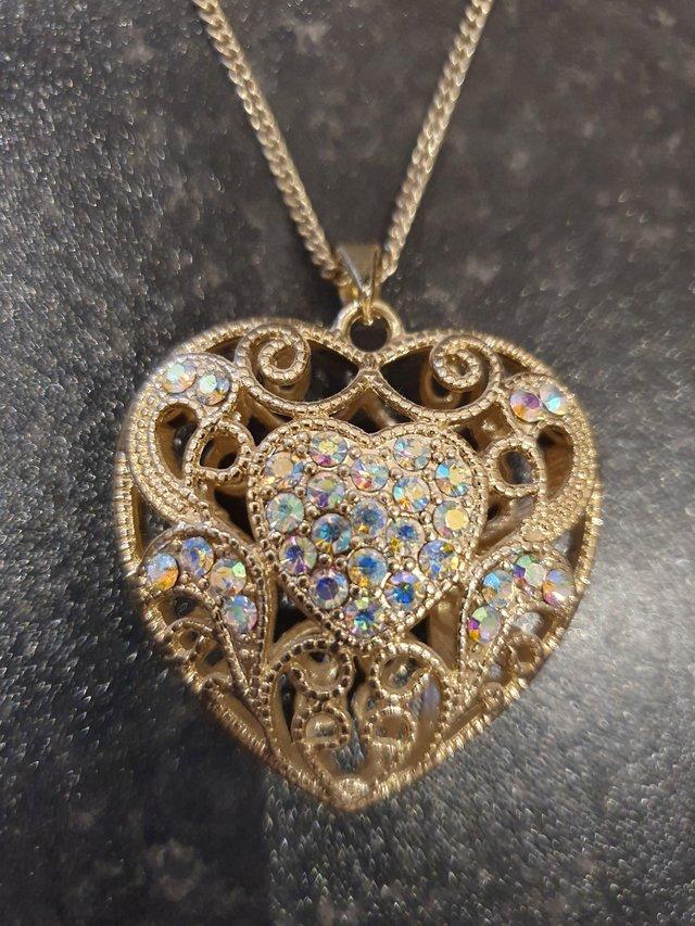 Preview of the first image of Gold colour dimante 3D heart necklace.