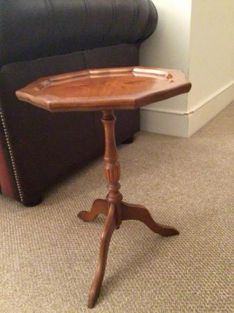 Image 2 of A yew wood side table with three legs