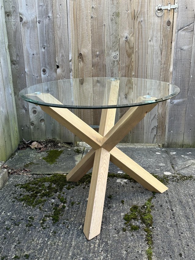 Preview of the first image of Glass Top Dining Table with Oak Legs.