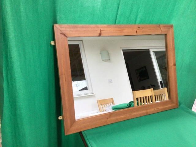 Preview of the first image of Wood framed wall-mounted mirror.